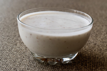 Organic probiotic milk kefir with flax seed in glass bowl.
