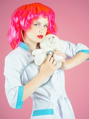 Woman wearing medical uniform and red wig