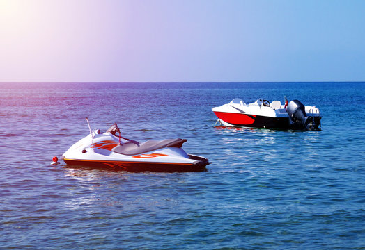 empty jet ski and motor boat on water, sunlight effect