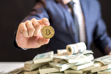 Businessman receive a lot of Money from Smartphone, Businessman Holding Bitcoin Isolated on black background, Digital Money and Bitcoine Concept.