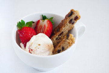 Slices of cake with raisins, strawberries and ice cream