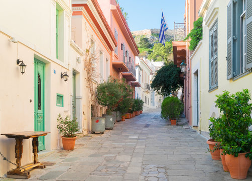 small paved street of Placa district with Acropolis hill in Athens, Greece