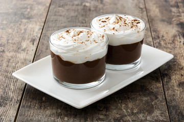 Chocolate mousse on wooden table. Copyspace.
