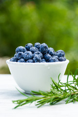 Juicy organic blueberries on white table.