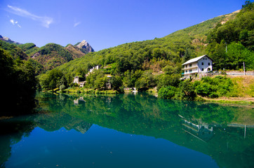 Fototapeta na wymiar mountain lake with small hamlet and historic church