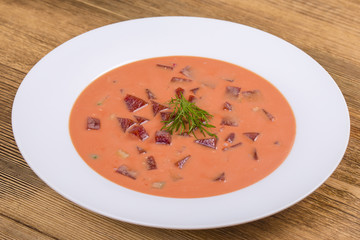 Cold borscht - speciality for hot summer days. Vegetable cold soup with beet, cucumber, potato, radsih and egg . Close up