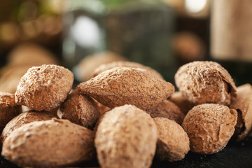 Pile of almond in shell closeup shot, selective focus