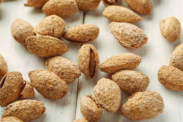 Almond in shell on a white table, side view, closeup