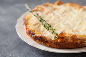 Fresh round fish pie on dark background