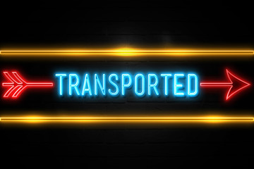 Transported  - fluorescent Neon Sign on brickwall Front view