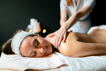 Obraz na płótnie Canvas Beautiful woman enjoying massage treatment