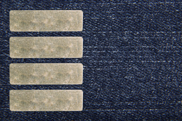 Denim blue fabric with four metal label for your text. The texture is a close-up macro shot.