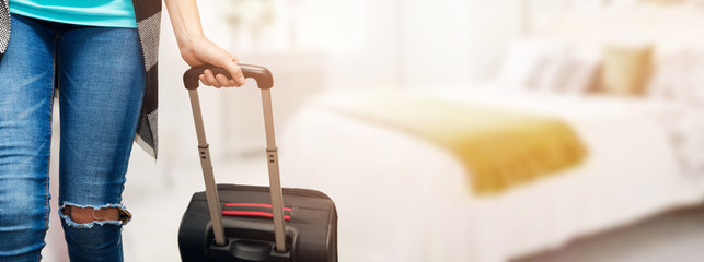 time for vacations - woman with luggage suitcase in bedroom ready for travel