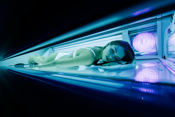 Beautiful woman lying in solarium