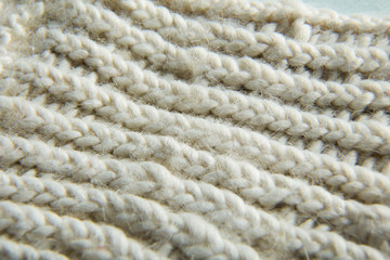 Extremely close-up. White knitted scarf, texture.