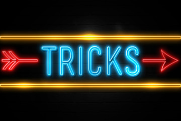 Tricks  - fluorescent Neon Sign on brickwall Front view