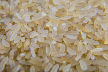 A bunch of rice on a plate close up. Rice as an ingredient for soup making. Macro shooting.