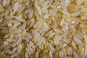 A bunch of rice on a plate close up. Rice as an ingredient for soup making. Macro shooting.