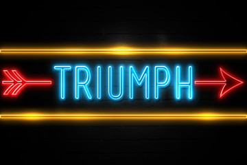 Triumph  - fluorescent Neon Sign on brickwall Front view