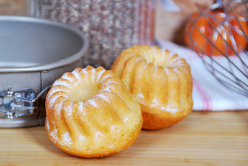 sweet muffins with icing sugar and a glass of milk