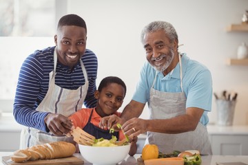 Multi-generation family preparing food in kitchen