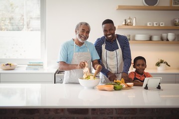 Obraz na płótnie Canvas Multi-generation family preparing food in kitchen