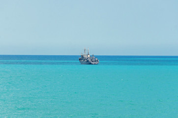 Obraz premium Boat or ship navigating on blue Black Sea water, cargoboat