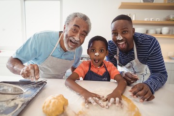 Multi-generation family with flour on the nose standing in the