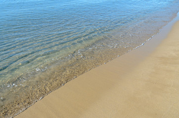 Fototapeta na wymiar The Black Sea beach with golden sands, blue fresh clear water, bulgarian shore