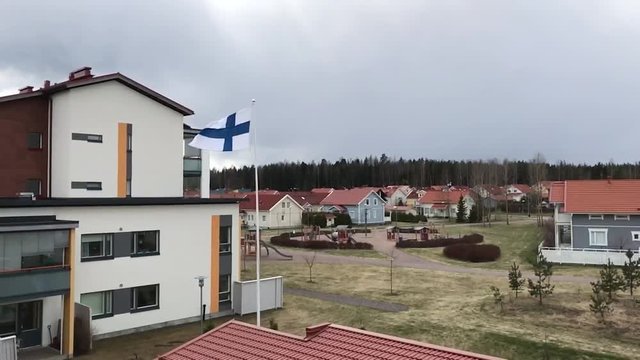 Finnish flag flutters in the wind in a slow-motion