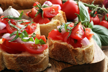Bruschetta with tomatoes, herbs and oil on toasted garlic cheese bread toasted with chopped tomatoe