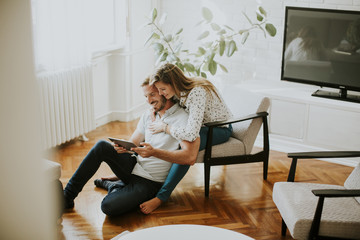 Couple using digital tablet together