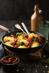 Carbonara paste with parmesan cheese and cherry tomatoes in a frying pan