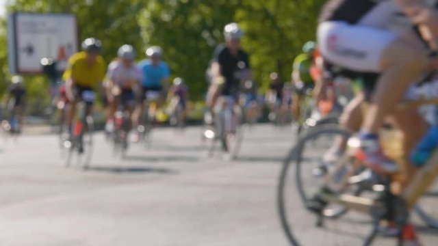 Blurred shot of a large group of cyclists.
