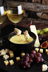 Gourmet Swiss fondue dinner on a winter evening with assorted ch