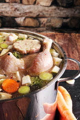 Bone broth made from chicken with carrots, onions various fresh