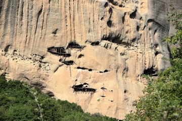 Caves in Rock Face - Askitiria or extreme hermitages above St. Antony’s hermitage. Meteora , central Greece.