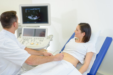 pregnant woman receiving ultrasound treatment in hospital