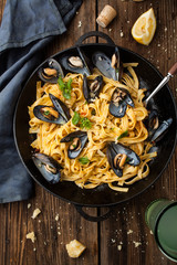 Pasta with mussels and sauce in a frying pan