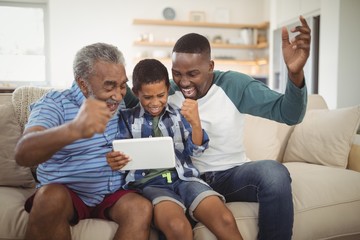 Multi-generation family using digital tablet in living room