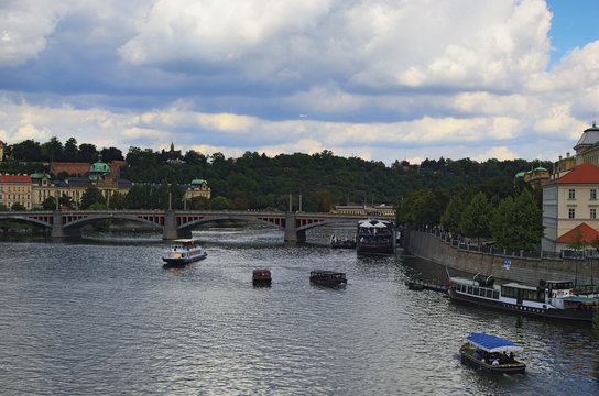View of Manes Bridge and river Vltava. Two boats are rolling tourists. Prague, The Czech Republic