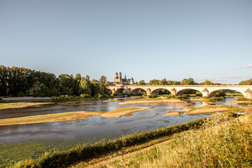 Landscape view on the river and old arch bridge in Orleans city during the sunset in France