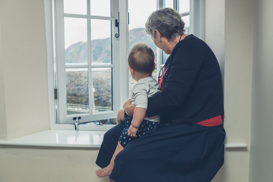 Senior woman with grandchild by the window