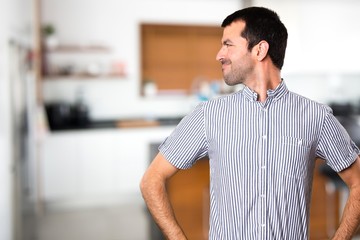 Obraz premium Handsome man looking lateral inside house