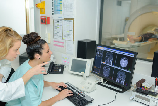 magnetic resonance and a nurse showing results