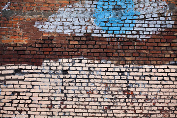 Textured old red brick wall with white blue paint