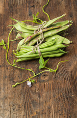 Fresh green beans on a wooden background