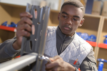 young african carpenter working in workshop