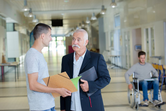 male student seeking advice from a teacher