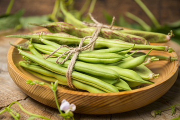 Fresh green beans on a wooden background